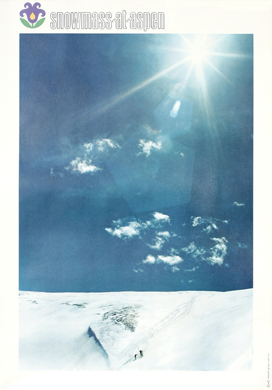 Three people hike up expanse of snow following ski trails; blue, white, black