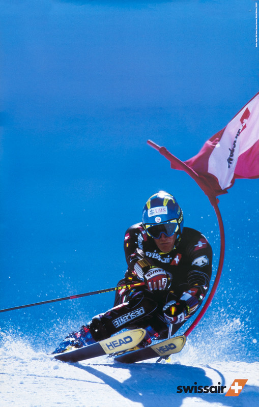 Racing skiier dodges flag; blue, white, red, black