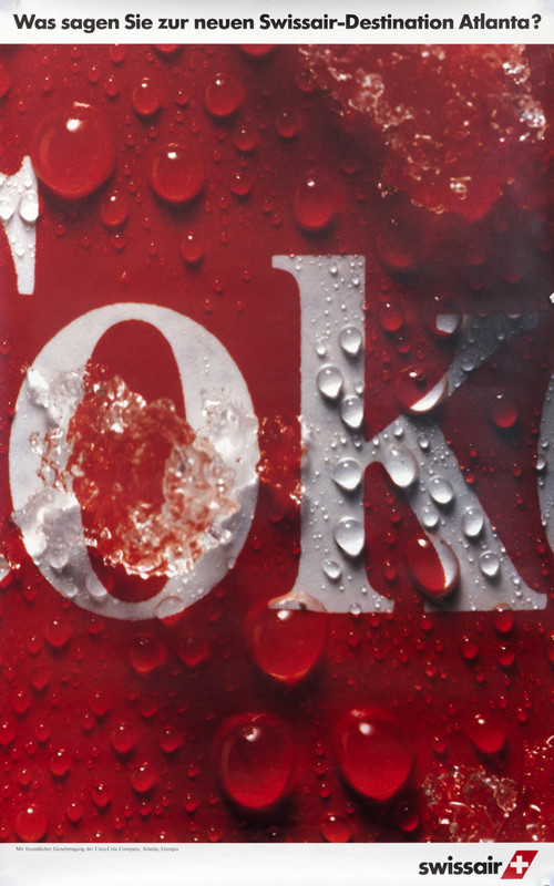 Close up photo of Coca Cola can with water drops and ice dripping down; red, white