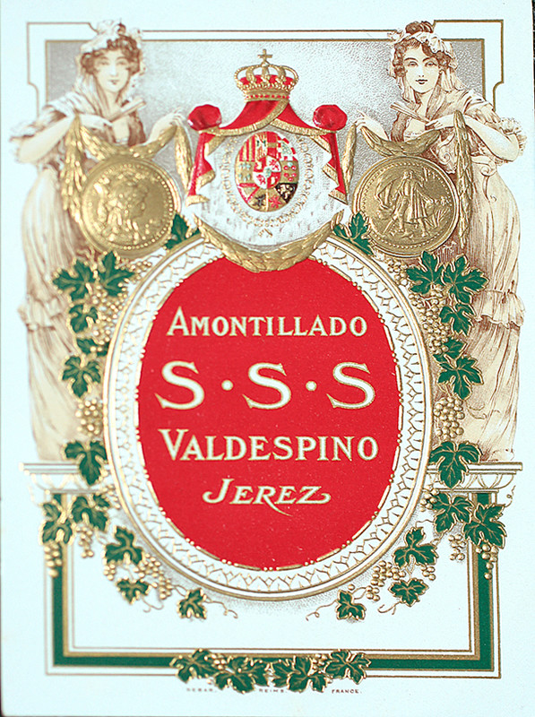 Spanish beauties flank rondelle with medallions, grape vines, and heraldry; red, gold