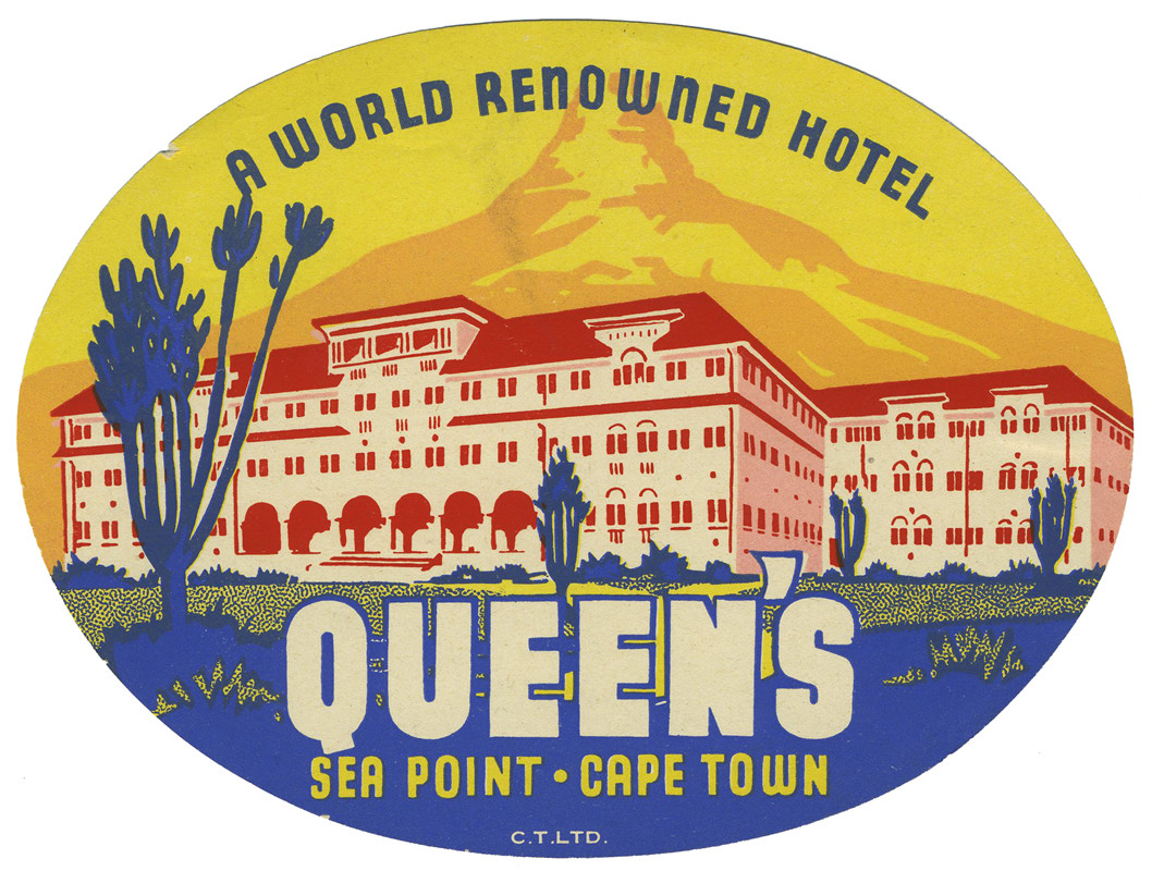 View of grand hotel in front of mountain; red, yellow, blue