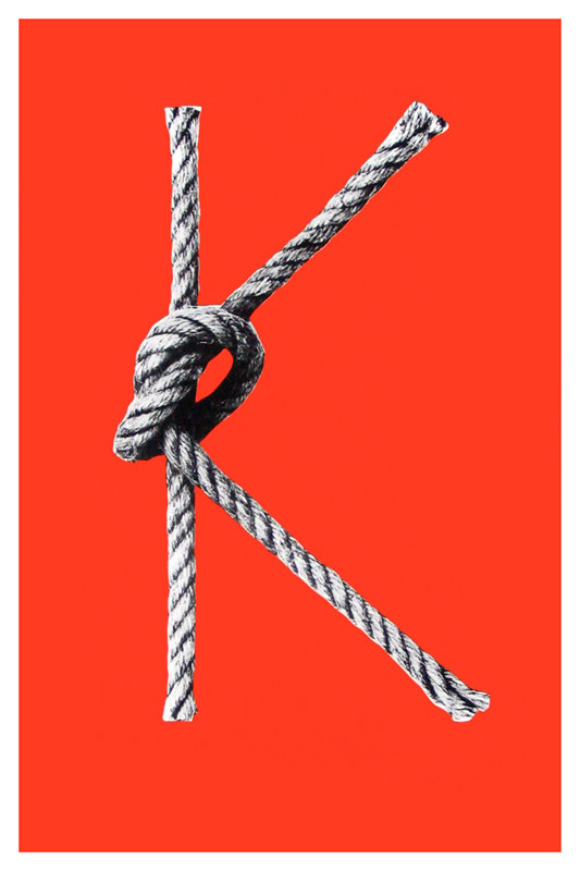 Lowercase letter "K" formed by knotted rope; black, white, orange