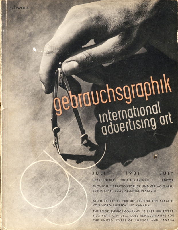 Hand holding a compass; orange, black, white