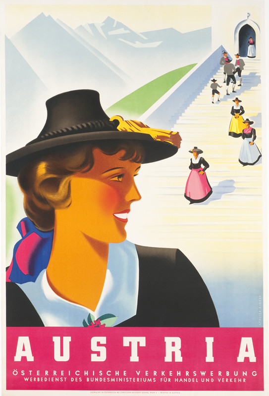 Close up view of woman in profile wearning hat, people exiting church, mountains behind; red, blue, white