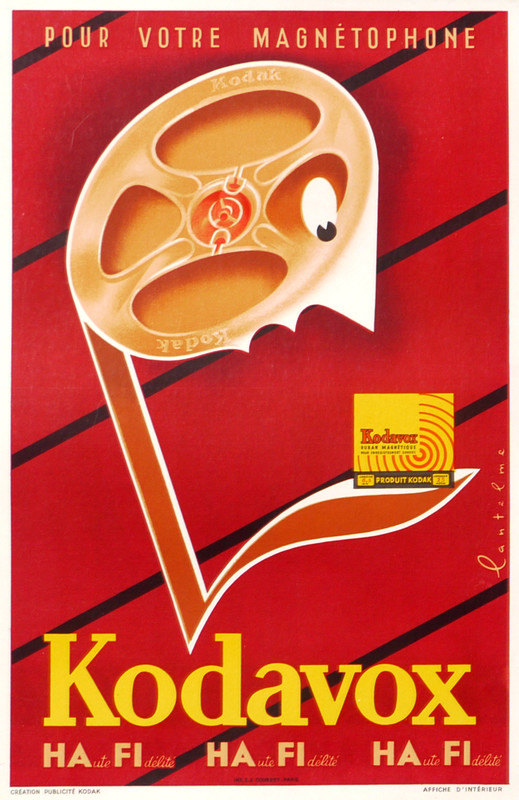 Cartoon music note with tape-reel head gawks at product box; red, purple, yellow