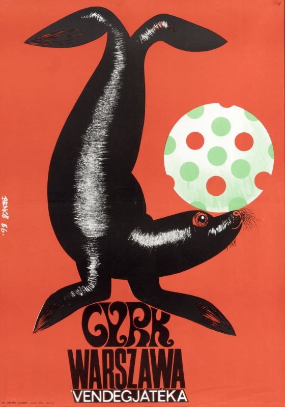 Seal balances polka-dotted ball; red, black, green. White