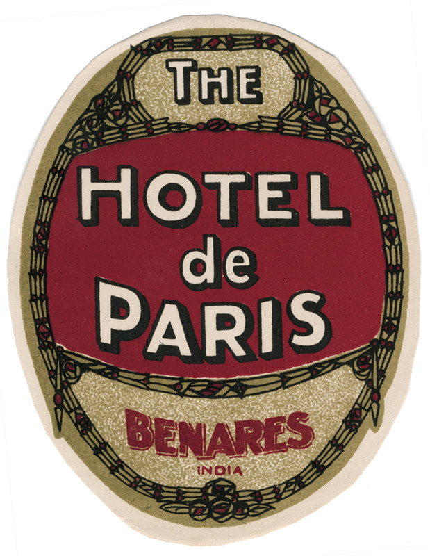 Oval label with text and geometric design; red, black, olive