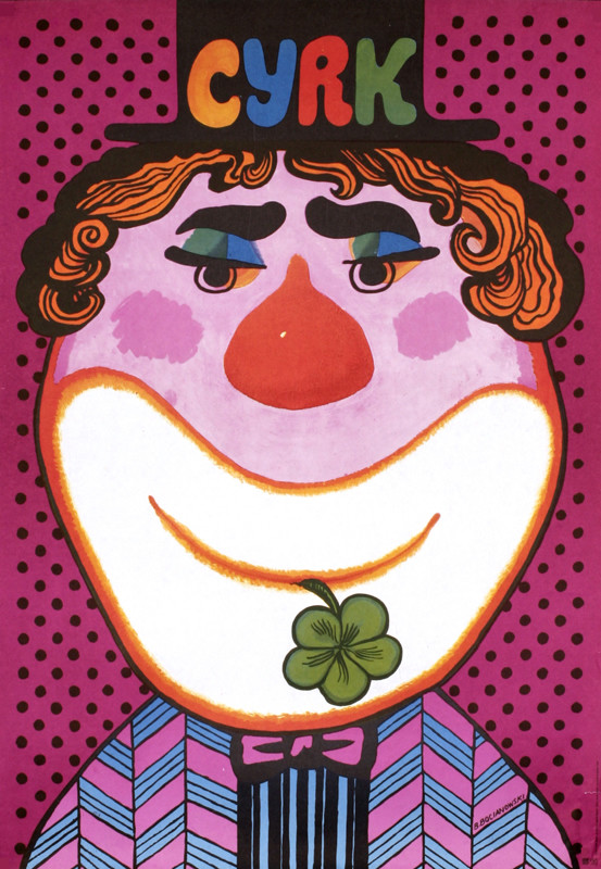 Clown in hat with shamrock in his mouth; pink, purple, red