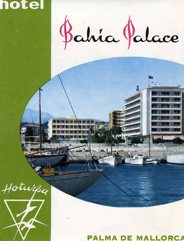 View of hotel from seaport; white, green, blue