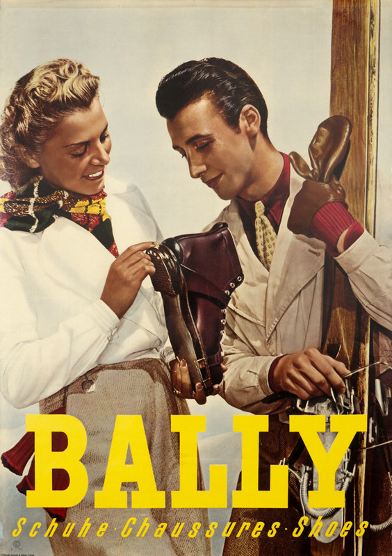 Man and Woman looking at a ski shoe; man holding skis