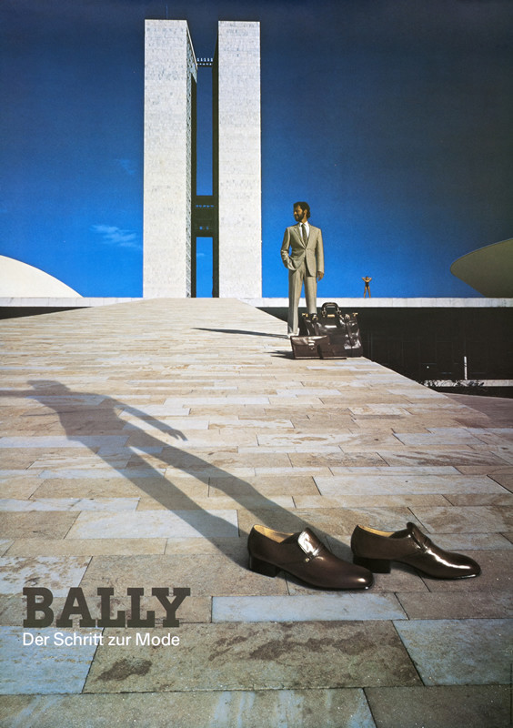 Brown mens shoes, shadow of man against modern buliding; brown