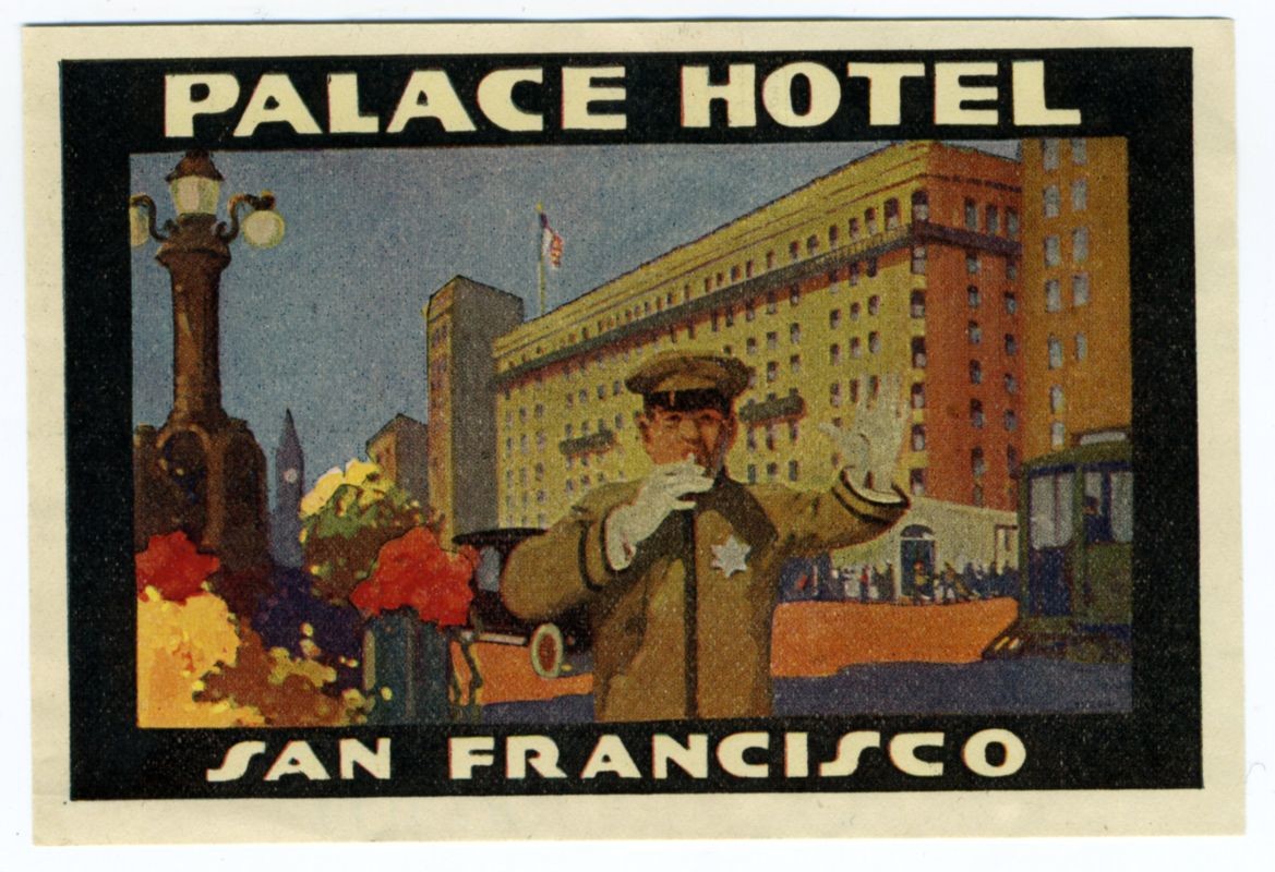 Bellman in front of grand hotel directs traffic; black, white, orange, blue