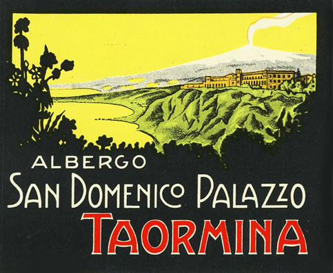 View of hotel and coastline of Taormina, Sicily from trees; black, red, green, yellow