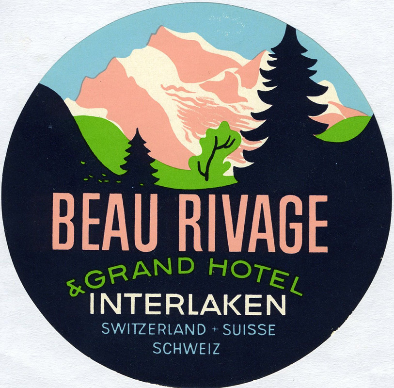 View of mountainside and surrounding forestry; black, pink, blue