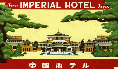 Japanese hotel surrounded with trees in foreground, Japanese lettering on bottom border; red, green, yellow, brown