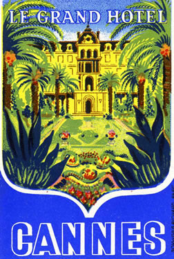 View of hotel and lush palm trees; blue, green, yellow, red