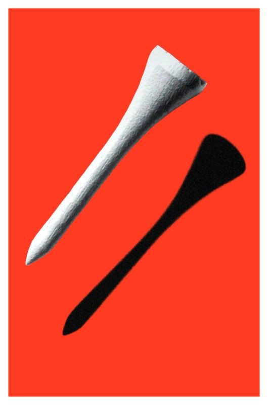 Golf tee casts shadow; black, white, orange