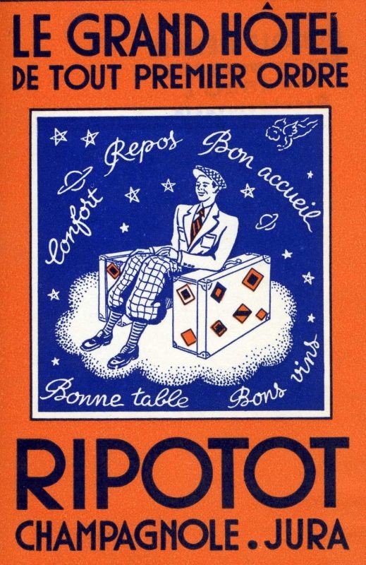 Dapper gentleman sits between two suitcases covered in luggage labels; blue, orange, white