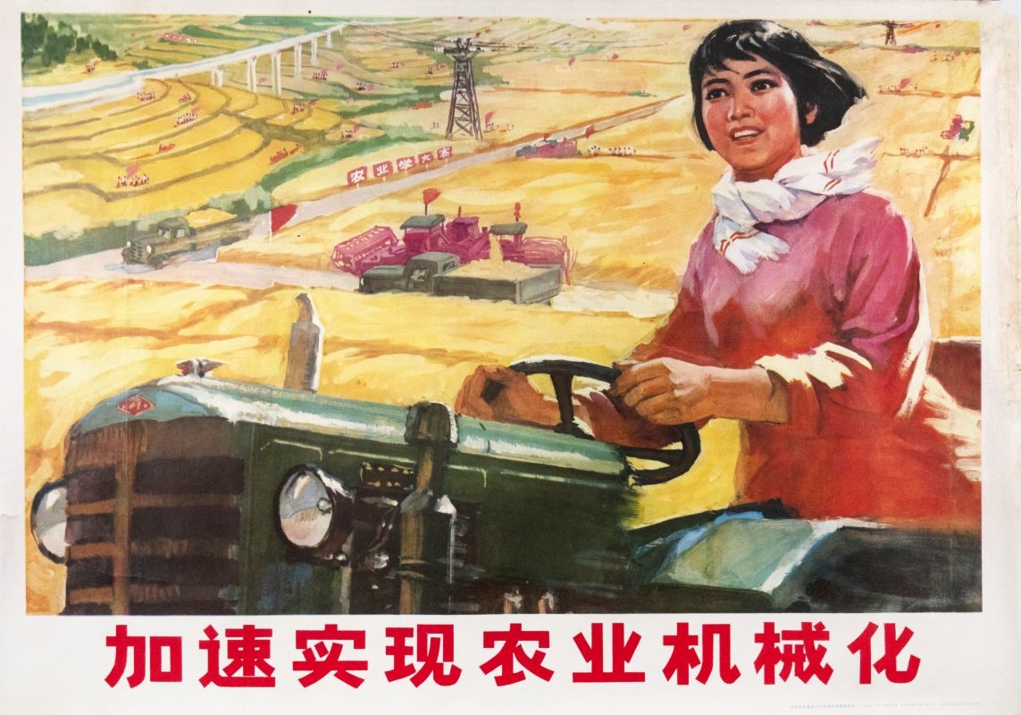 Woman smiling while driving a tractor though field; red, yellow, pink, green