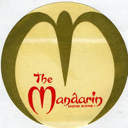 Stylized M in circle-shaped label; gold, red
