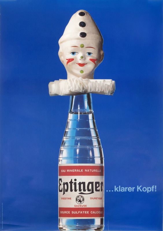 Toy clown's head caps Eptinger bottle  "Clearer head!" slogan; blue, red, black, green