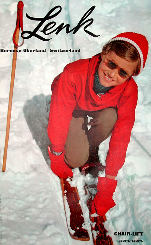 Boy kneels to adjust skis; red