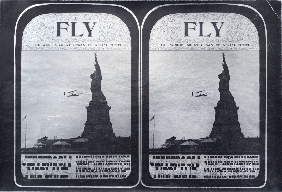 Airplane flies in front of Statue of Liberty; black, silver