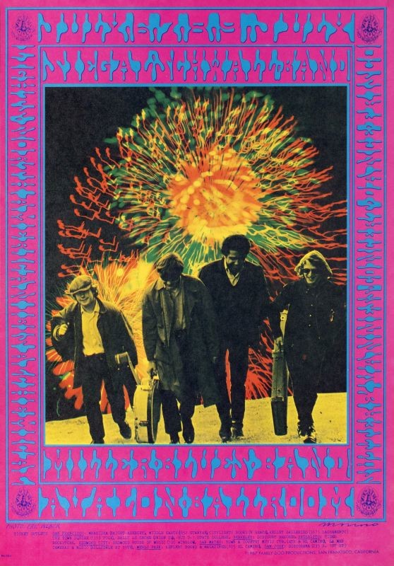 Band members walk up hillside with instrument cases, fireworks behind Steve Miller ; pink, blue, orange, yellow, neon