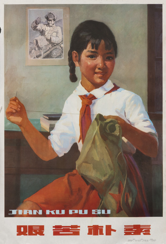 student sewing up an outfit; white, red, blue