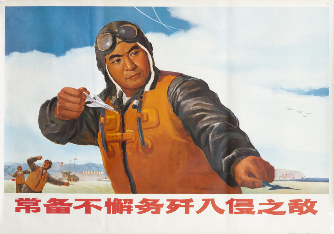 Pilot aims model planes toward ground; orange, white, brown