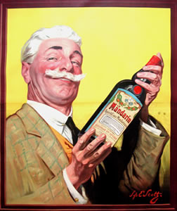 Portrait of a nicely dressed gentleman with rosey cheeks and a handlebar mustache holding up bottle of orange liqueur