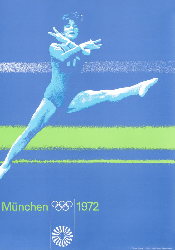 Gymnast leaps through air in floor routine; purple, green