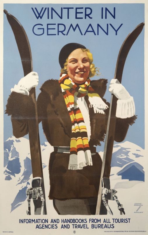 Woman stands with her skis at mountains; blue, brown, yellow, black